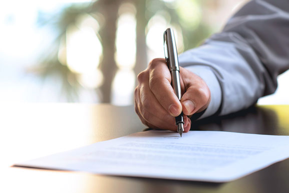 Nahaufnahme einer Hand während einer Unterschrift